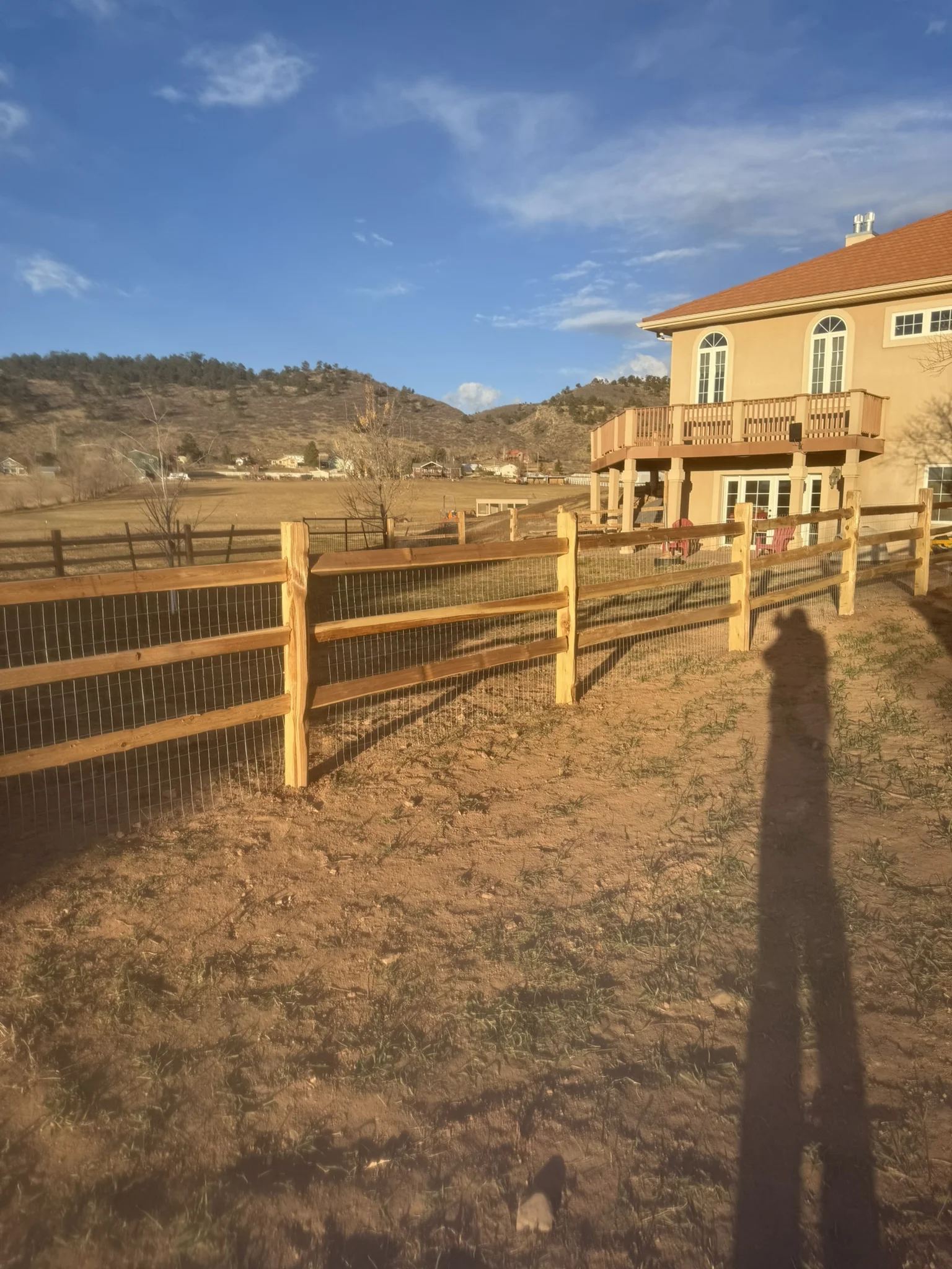 Split-rail wood fence with mountain views