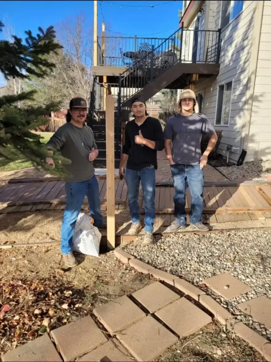 The Fort Collins Fence crew standing in front of a completed cedar privacy fence in a Fort Collins neighborhood