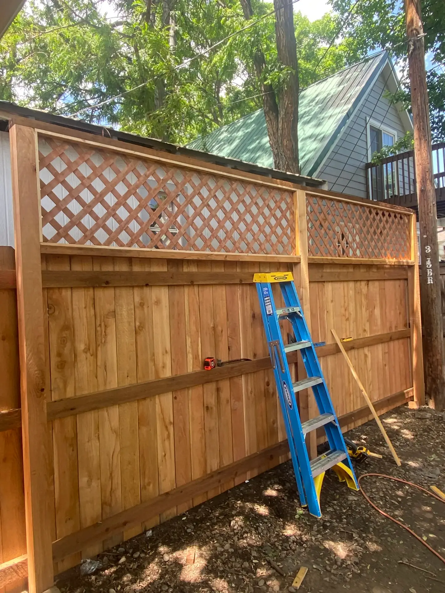 Cedar fence with lattice top panel under construction